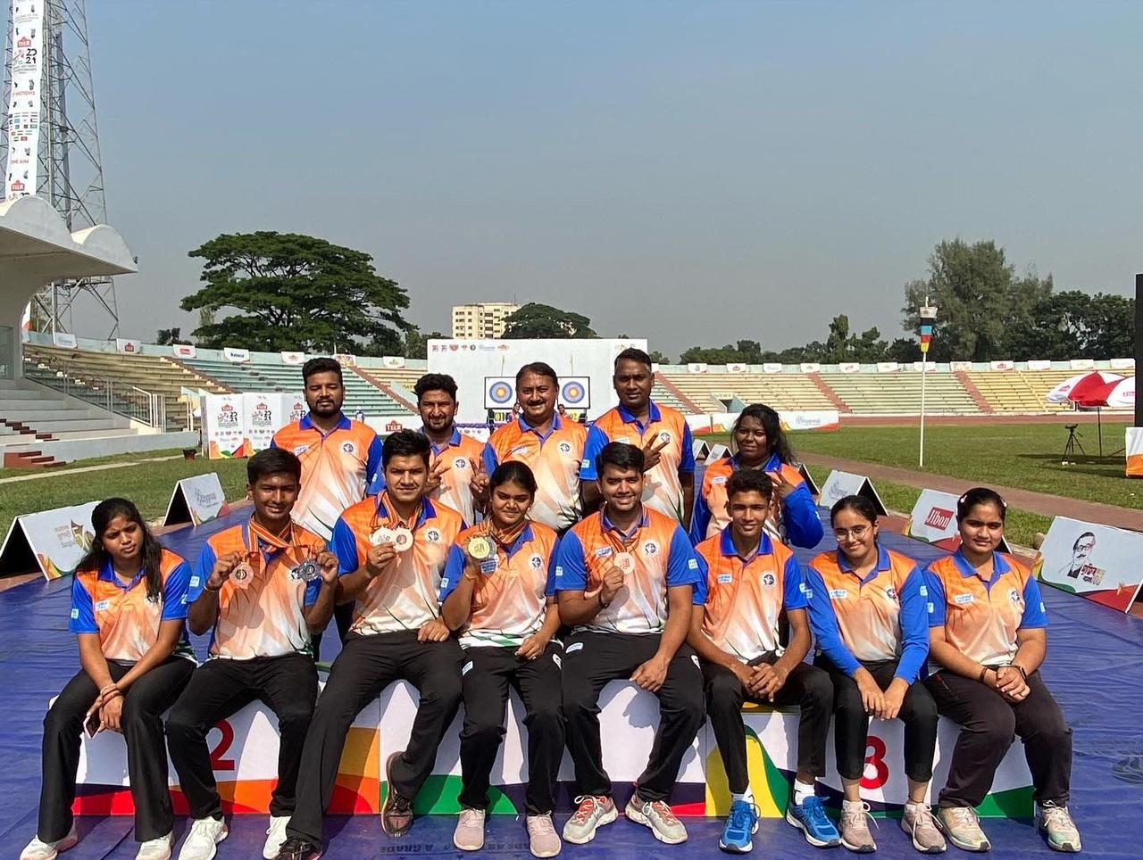 Archery athletes and support staff with medals