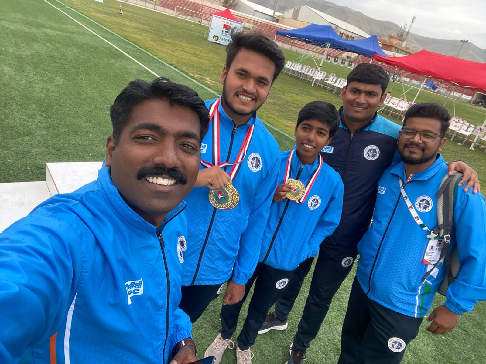 Group selfie with medal-winning athletes