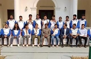 Team group photograph at a building entrance